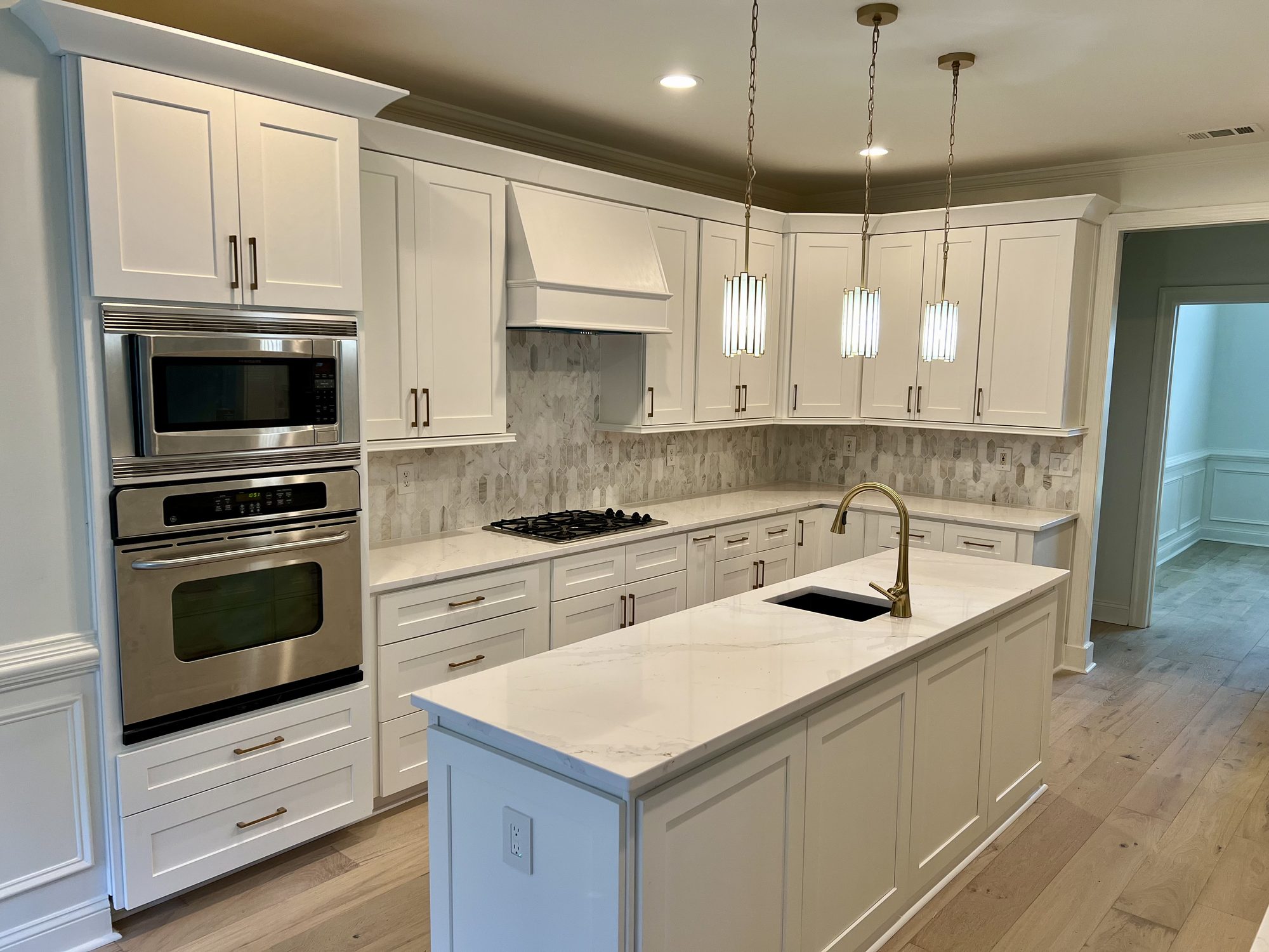 Custom kitchen with brass pendants