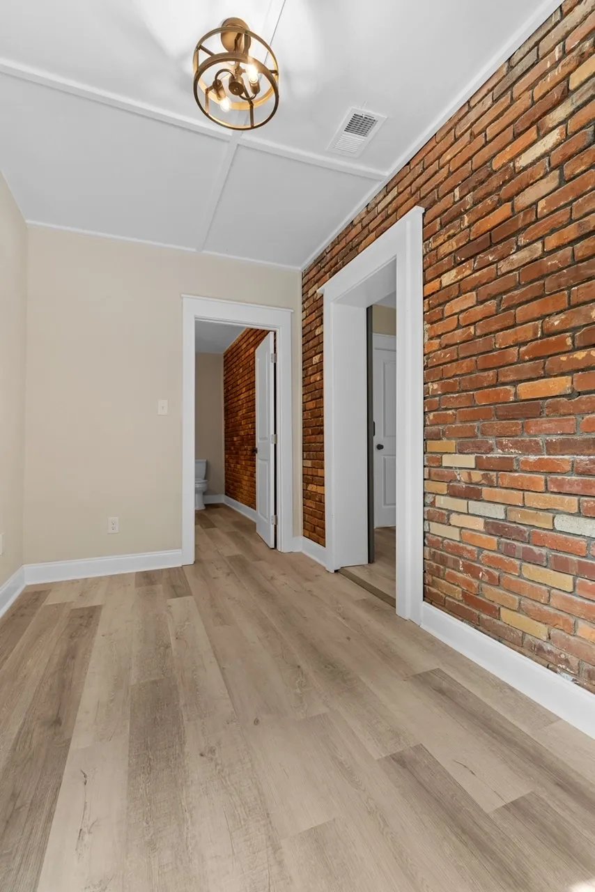 Hallway with brick wall and stairs