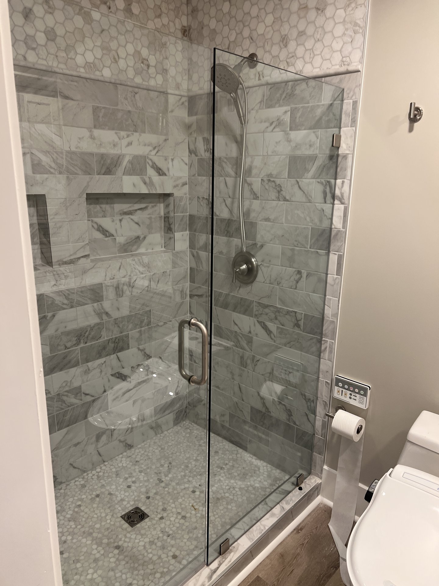 Frameless glass shower with marble